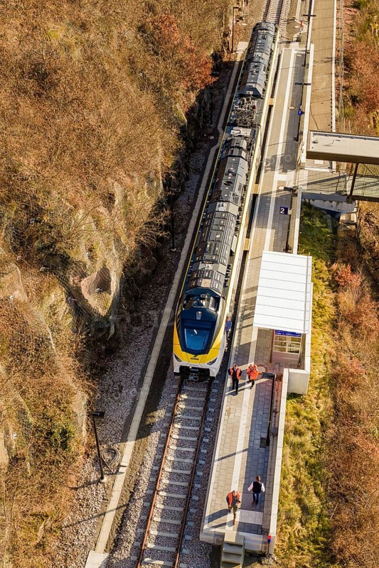 Train stops at a station in the rocky hills, viewed from above, test run on the new Hermann-Hesse railway with Siemens Mireo Plus B trains, Calw, Germany