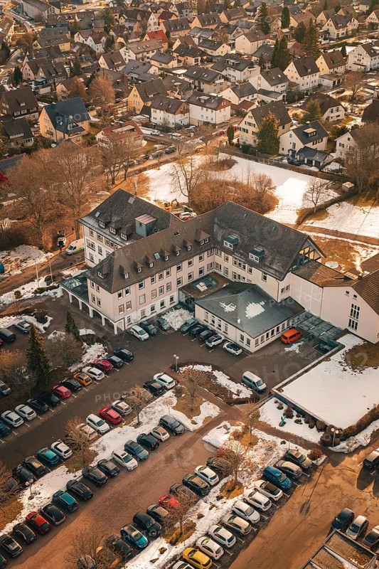 An overview of a building with addresses, parking lot and light snowfall, District Office, Freudenstadt, Black Forest, Germany