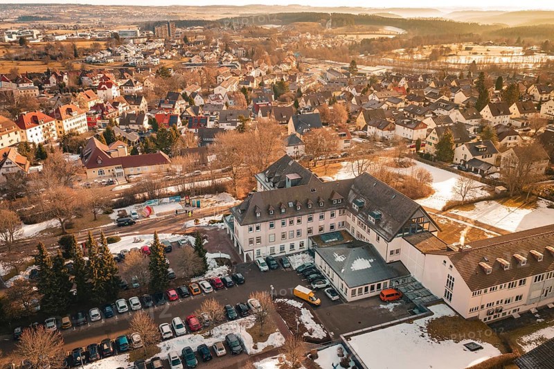A part of a city with buildings, open parking areas and snow to see, District Office, Freudenstadt, Black Forest, Germany