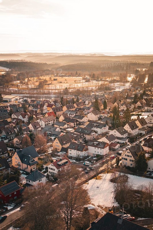 A landscape view of a village at sunset in winter with snow-covered roofs, Freudenstadt, Black Forest, Germany