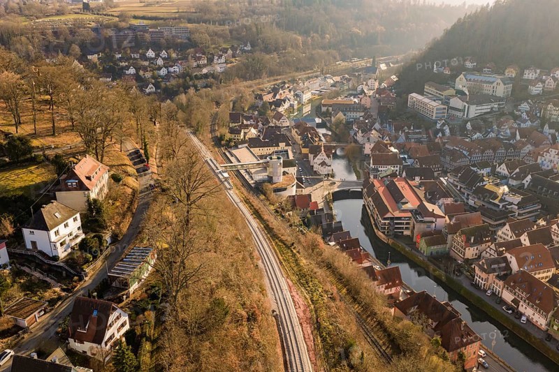 City landscape with train tracks and river from a bird's eye view, measurement trip on the new Hermann-Hesse railway with Siemens Mireo Plus B trains, Calw, Germany