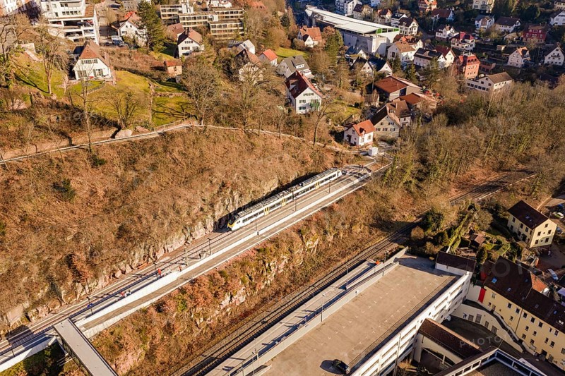 Houses and urban structure on hilly landscape with train on tracks, test run on the new Hermann-Hesse railway with Siemens Mireo Plus B trains, Calw, Germany