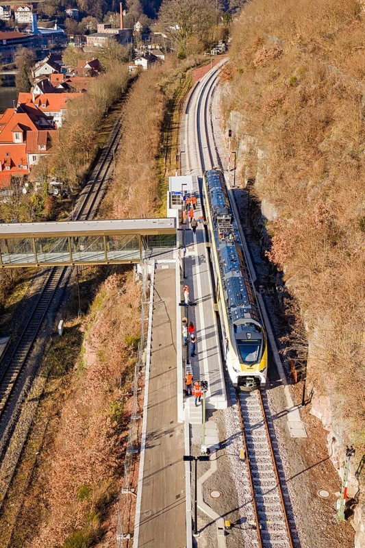 Train on platform in hilly landscape, with bridge and urban background, test run on the new Hermann-Hesse railway with Siemens Mireo Plus B trains, Calw, Germany