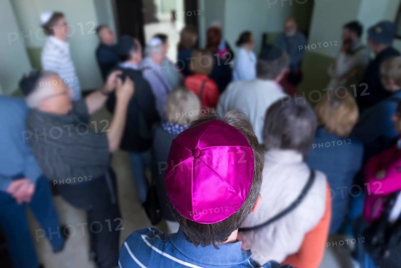 Visitors wear a kippah while visiting a synagogue, Ukraine