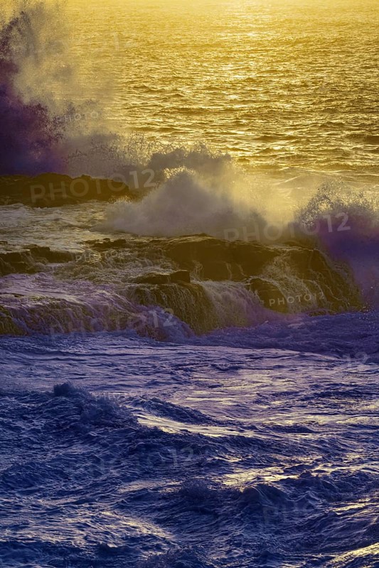 Dusk at sea with big waves and a golden horizon, purple colored ocean, Playa Blanca/Yaiza Lanzarote