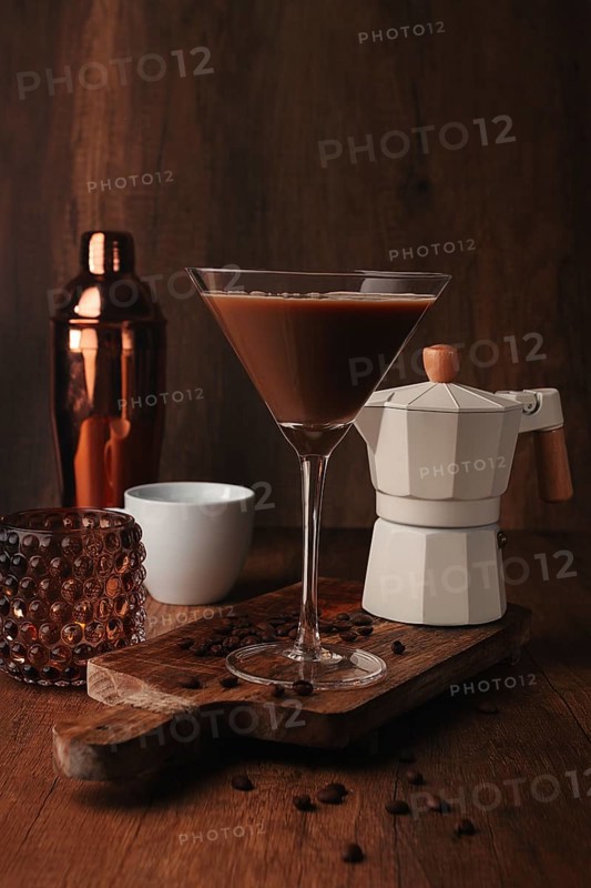 Espresso martini cocktail, alcoholic drink, shaker and geyser coffee maker, on a wooden background