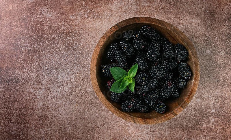 Blackberries, in a wooden bowl, top view, no people