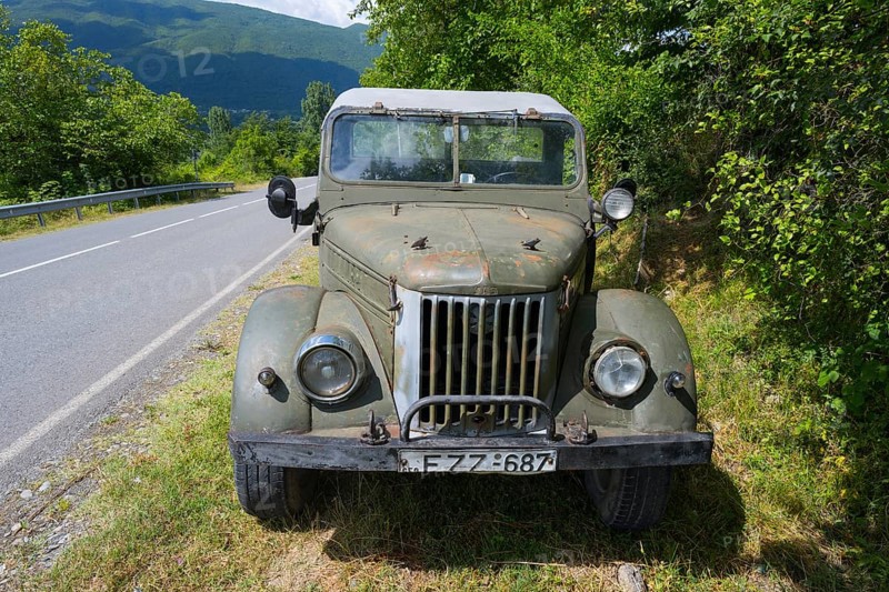 Front view of an old off-road vehicle on the side of the road in a rural setting, four-wheel drive vehicle, GAZ-69, Georgia