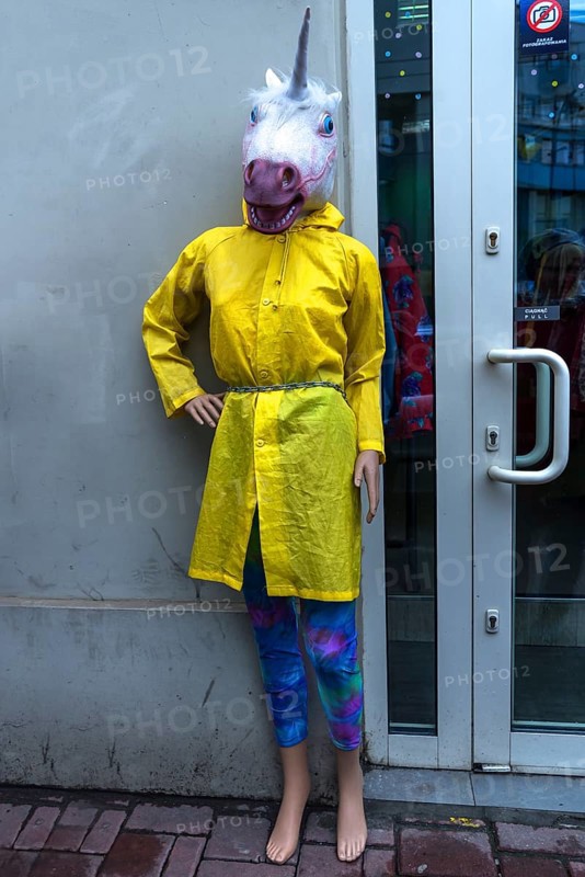 Mannequin with rain cape and unicorn mask, Krakow, Poland