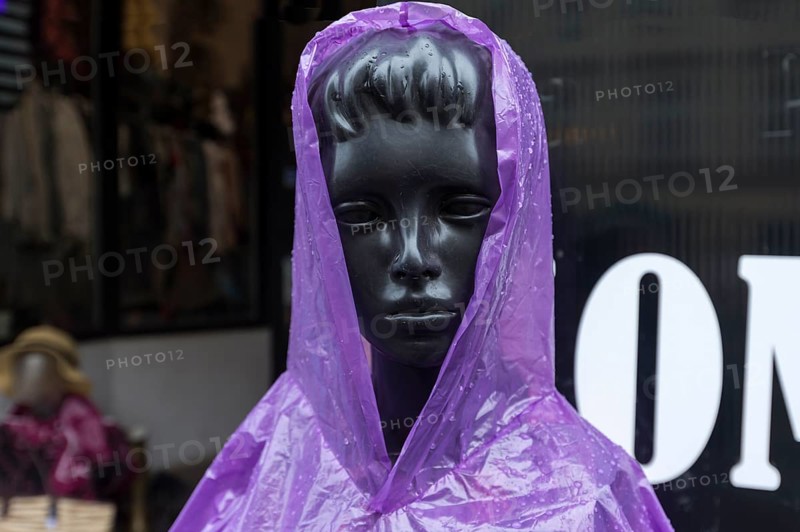 Window mannequin with rain cape in rain, Krakow, Poland