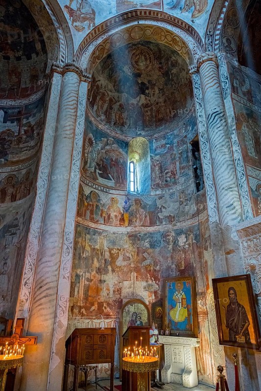 Church interior with frescoes and columns illuminated by a mystical ray of light, Nikorzminda Cathedral, Racha-Lechkhumi region, Lower Svaneti, Georgia