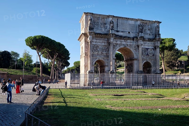 Arch of Constantine with tourists on sunny day, Lazio, Italy