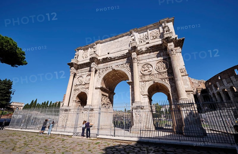 Arch of Constantine with detailed reliefs under blue sky, Rome, Lazio, Italy