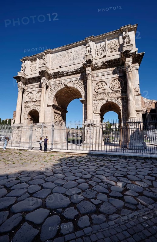 Arch of Constantine with detailed reliefs under blue sky, Rome, Lazio, Italy