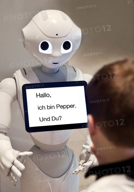 Pepper, a humanoid robot with a tablet and a boy in dialogue, artificial intelligence, AI, Germany
