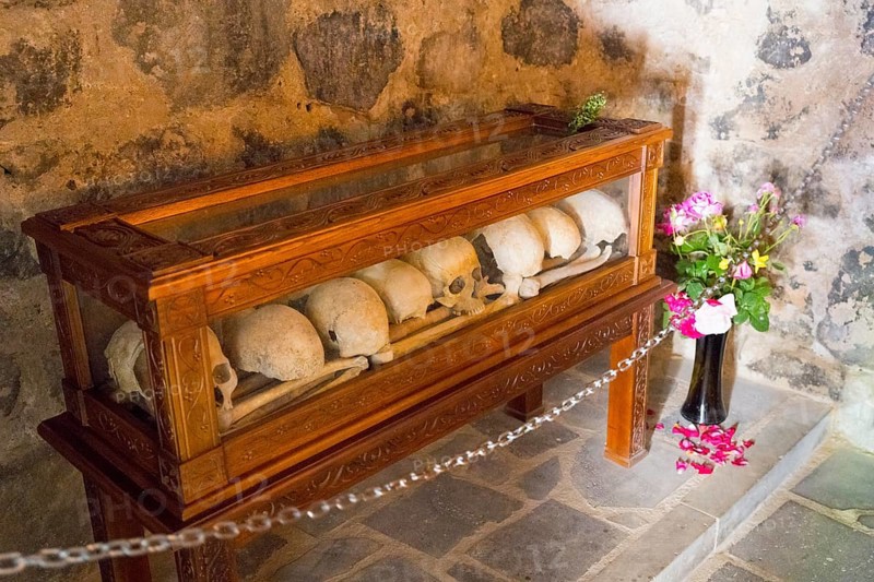 Bones in a wooden display case with flowers in a historical context, Chitakhevi Church of St. George, The Green Monastery, Mtsvane Monastery, Samtskhe-Javakheti Region, Samtskhe-Javakheti, Georgia