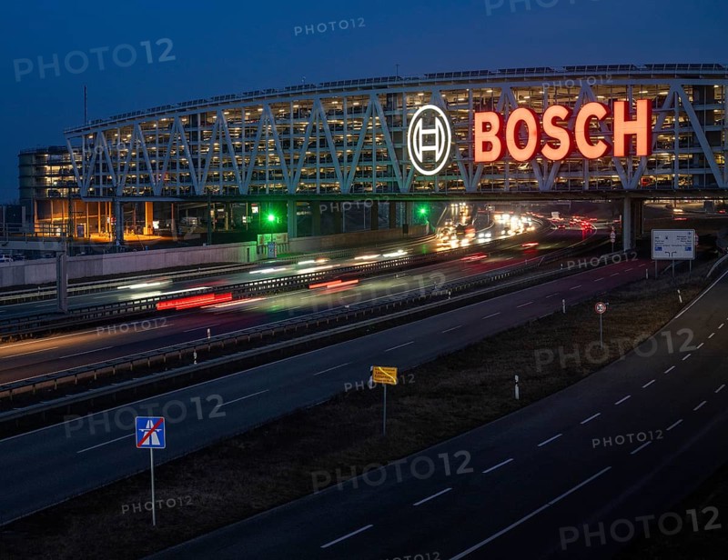 Traffic on the A8 motorway, blue hour, illuminated parking garage, Landesmesse Stuttgart, red-lit Bosch logo, second-largest logo in the world 55 meters wide, Baden-Württemberg, Germany