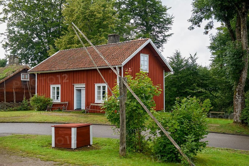 Red wooden house with green garden and trees, Linnés Råshult, Älmhult, Kronobergs län, Småland, Sweden