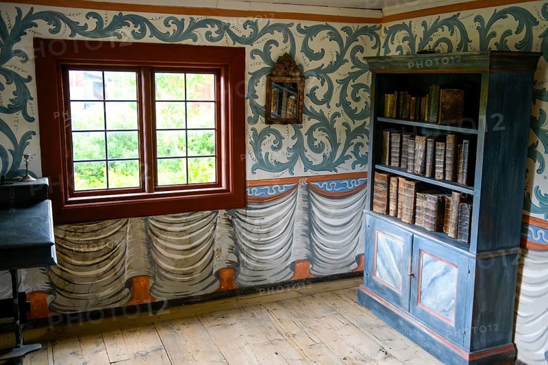 Small room with an antique bookshelf and artfully decorated walls next to a window in the birthplace of botanist and founder of the binary nomenclature Carl von Linné, Linnés Råshult, Älmhult, Kronobergs län, Småland, Sweden