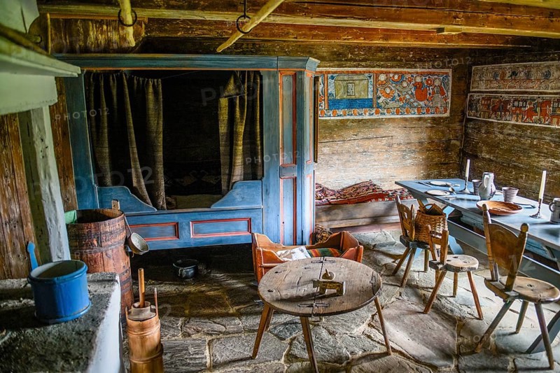 Rustic dining room with wooden table and chairs, wall paintings and antique charm in the birthplace of botanist and founder of the binary nomenclature Carl von Linné, Linnés Råshult, Älmhult, Kronobergs län, Småland, Sweden