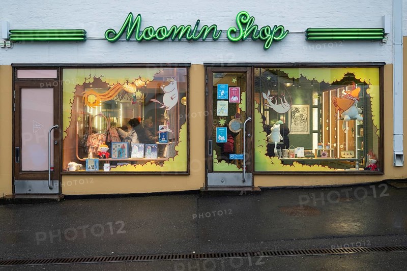 Illuminated shop window, shop in the city center selling merchandise and products related to the Moomin or Moomin book series by Finnish children's book author and illustrator Tove Jansson, Helsinki, Finland