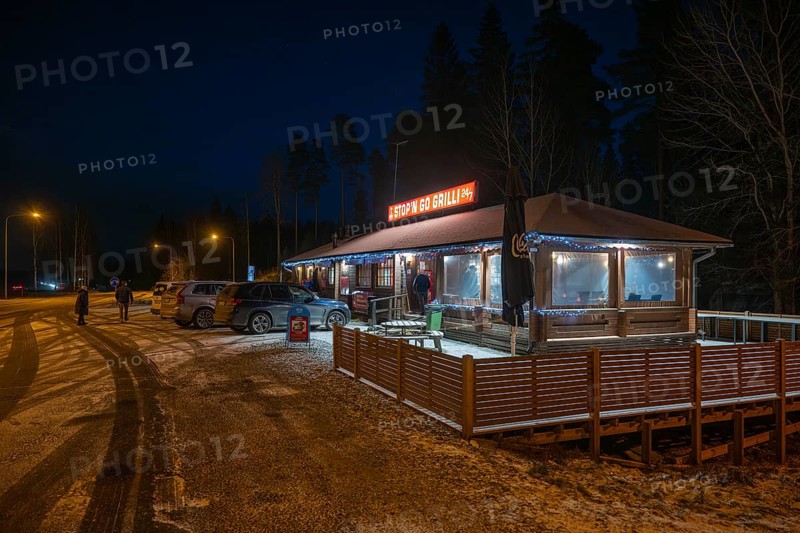 Illuminated rest stop, Stop'n Go Grilli or grill on the Finnish motorway in a wintry atmosphere, meeting place for truck drivers, near Helsinki, Finland
