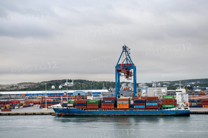 Container ship in port surrounded by several cranes Container bridges, Gothenburg, Västra Götalands län, Sweden and containers