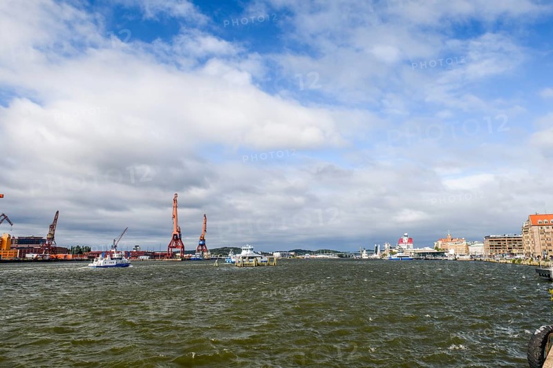 City and harbor landscape with cranes and cloudy sky, Gothenburg, Västra Götalands län, Sweden