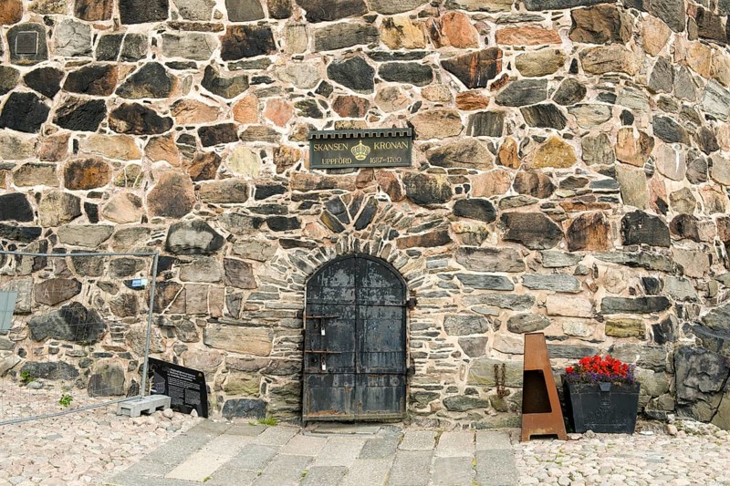 Detail of an old stone wall stone tower in Gothenburg's Skansen Kronan fortress with historical signs, rustic masonry, Gothenburg, Västra Götalands län, Sweden