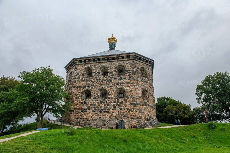 Massive historic stone fortress Skansen Kronan with a decorative crown on a hill surrounded by trees, Gothenburg's Skansen Kronan with historic signs, rustic masonry, Gothenburg, Västra Götalands län, Sweden