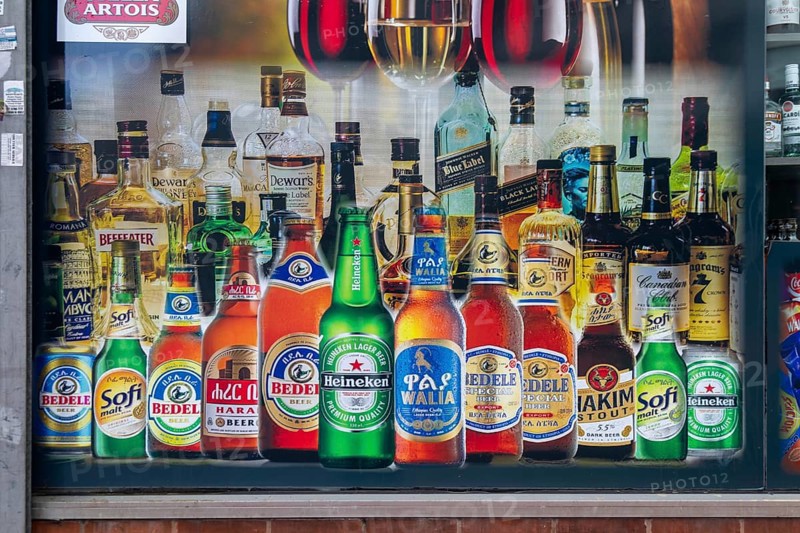 Picture of beer and spirits alcohol bottles on side of shop in town centre of Reading, Berkshire, England, UK