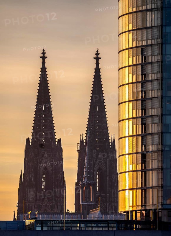 Cologne Cathedral, church towers, round façade of the Cologne Triangle Hochaus in Cologne-Deutz, sunset, North Rhine-Westphalia, Germany