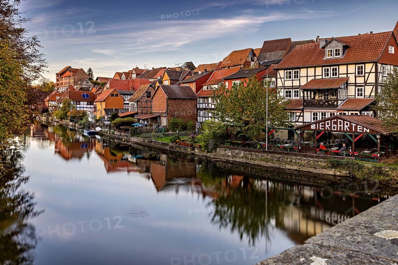 Beautiful reflection of half-timbered houses and beer garden in the river on an autumn day, The town of Bad Sooden Allendorf an der Werra in the Werra Meissner district of Hesse