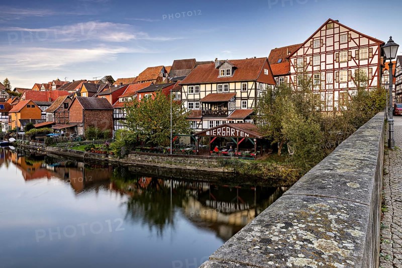 Half-timbered houses on a river with beer garden and bridge in an autumn atmosphere, The town of Bad Sooden Allendorf an der Werra in the Werra Meissner district of Hesse