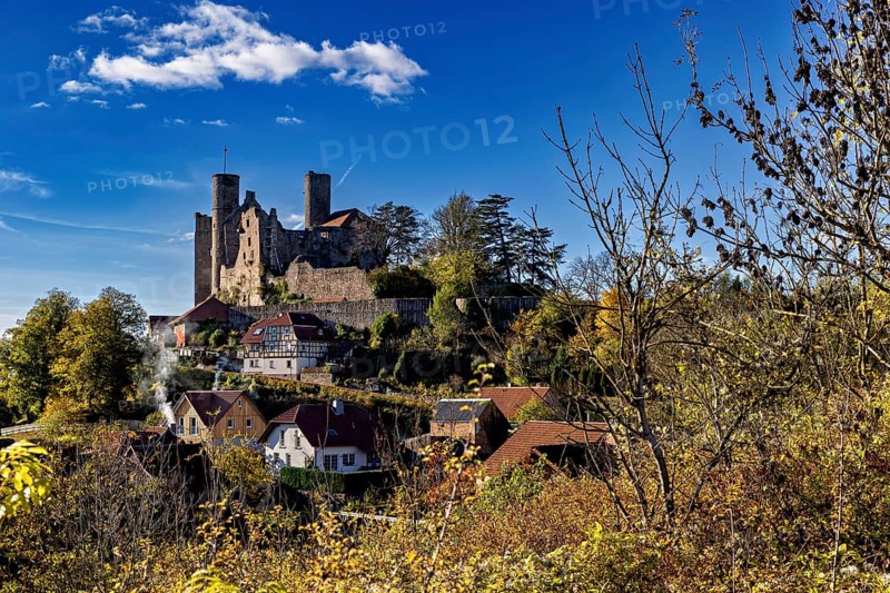 Autumn view of the village with castle on a hill under a clear sky, Hanstein Castle near Bornhagen in the Eichsfeld district of Thuringia