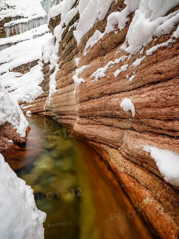 Taugl or Tauglbach flows through the snow-covered and icy red gorge, also Marmorklamm, Bad Vigaun, Tennengau, Salzburg, Austria