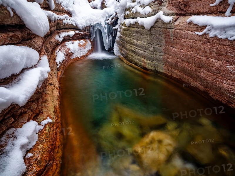 Taugl or Tauglbach flows through the snow-covered and icy red gorge, also Marmorklamm, Bad Vigaun, Tennengau, Salzburg, Austria