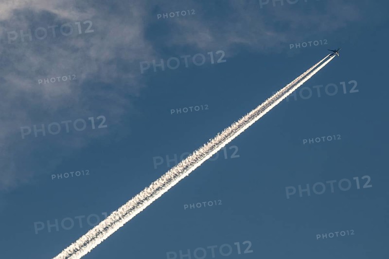 Contrails and passenger jets high in the sky