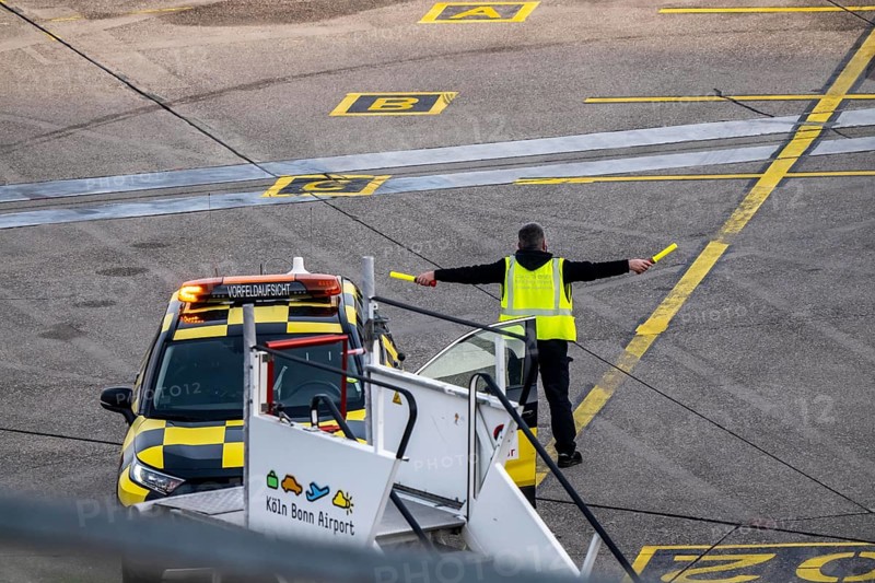 Instructor, apron supervision, an aircraft, after landing, at the parking position, at the terminal, gates, at the passenger bridge, Cologne/Bonn airport, CGN, North Rhine-Westphalia, Germany