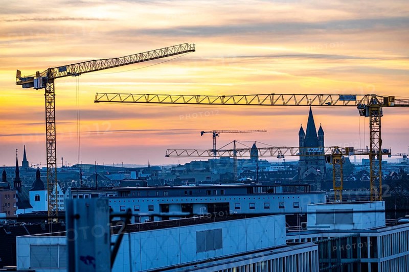 View of downtown Cologne, construction cranes from various construction sites, tower of Groß St. Martin church, North Rhine-Westphalia, Germany