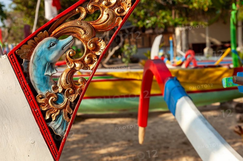 Restored, brightly painted outrigger fishing boats on Sanur beach, Bali, Indönsia