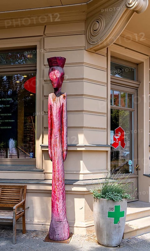 Wooden figure in front of a pharmacy, Luisenplatz, Potsdam, Brandenburg, Germany