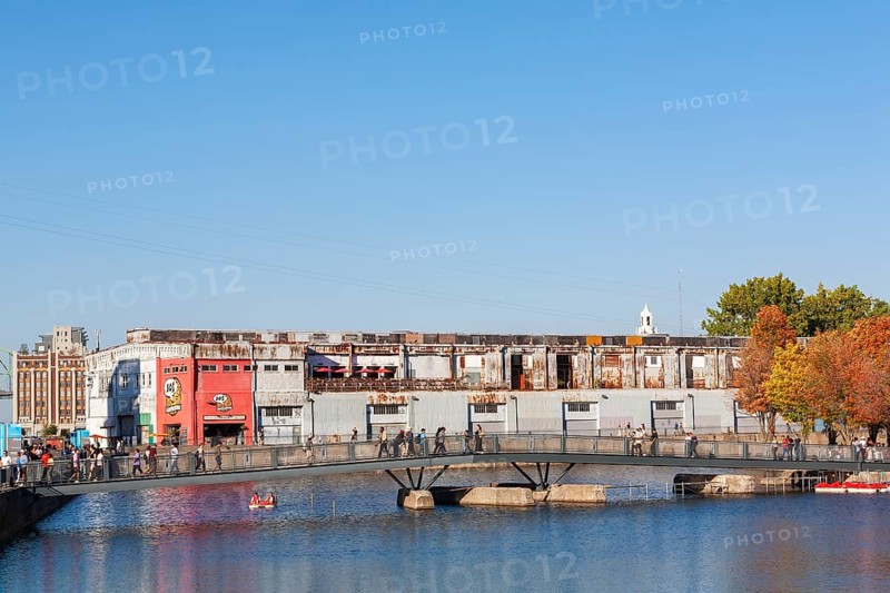 Pedestrian walkway bridge over Bonsecours basin leading to Parc du Bassin Bonsecours in autumn, Old Port of Montreal, Quebec, Canada