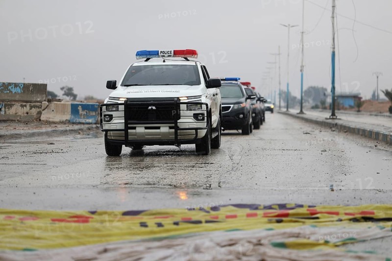 In Raqqa, Syria on January 18, 2026, a convoy of Syrian Government forces is seen advancing through the region, treading over flags of the Syrian Democratic Forces (SDF). This movement comes as government troops successfully take control of dozens of towns and villages across Northeast Syria following the withdrawal of Kurdish-led groups affiliated with the PKK, Raqqa, Tabqah, Syria