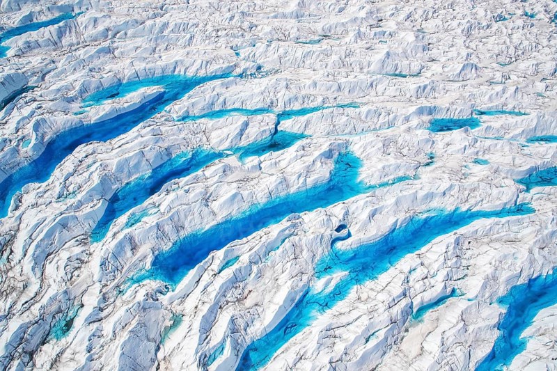 Aerial view of meltwater on the Greenland ice sheet, Arctic landscape, frozen wilderness, glaciers and snow-covered terrain, Climate change, Global warming, Greenland, North America
