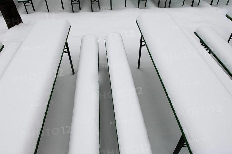 Winter in the English Garden, snow-covered beer garden tables and benches, Munich, Bavaria, Germany