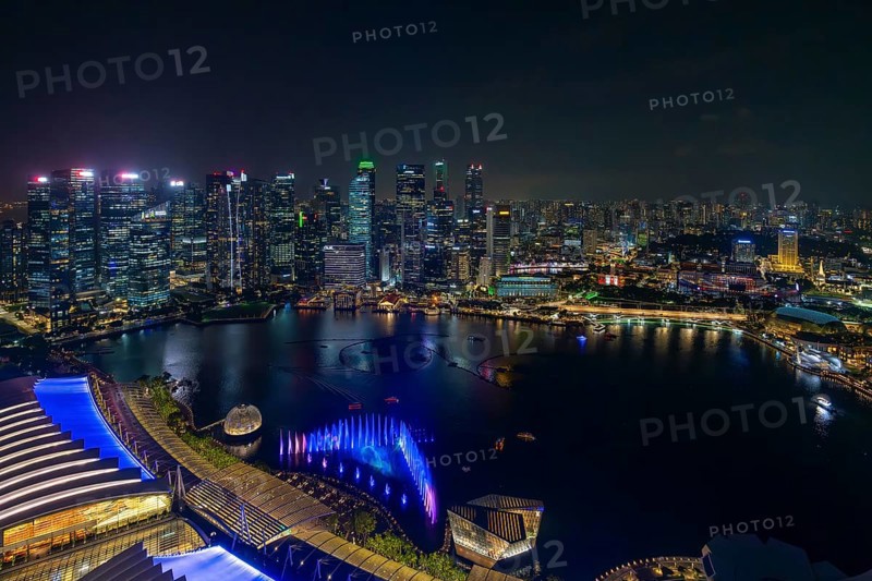 Aerial view from Marina Bay Sands SkyPark Observation Deck over the illuminated skyline of the city Singapore at night, Southeast Asia