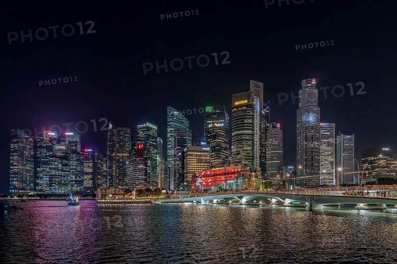 Skyline of the Central Business District, CBD with illuminated skyscrapers and Jubilee Bridge in the city Singapore at night, Southeast Asia
