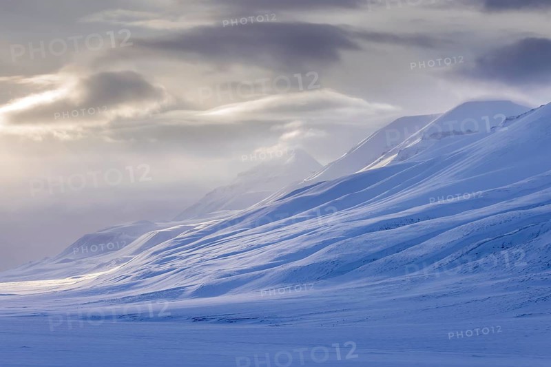 Snow covered mountain peaks along Adventdalen, Advent Valley near Longyearbyen at sunset in spring, Spitsbergen, Svalbard, Norway