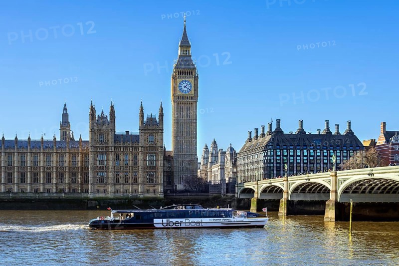Uber Boat river bus by Thames Clippers on River Thames, Westminster Bridge, Elizabeth Tower, Big Ben and Palace of Westminster in London, England, UK